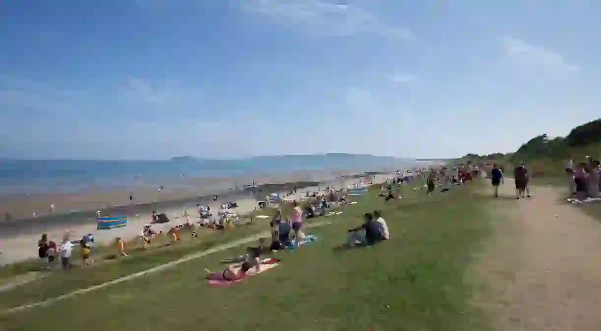 People relaxing at the seaside at Portmarnock beach, Dublin, Ireland