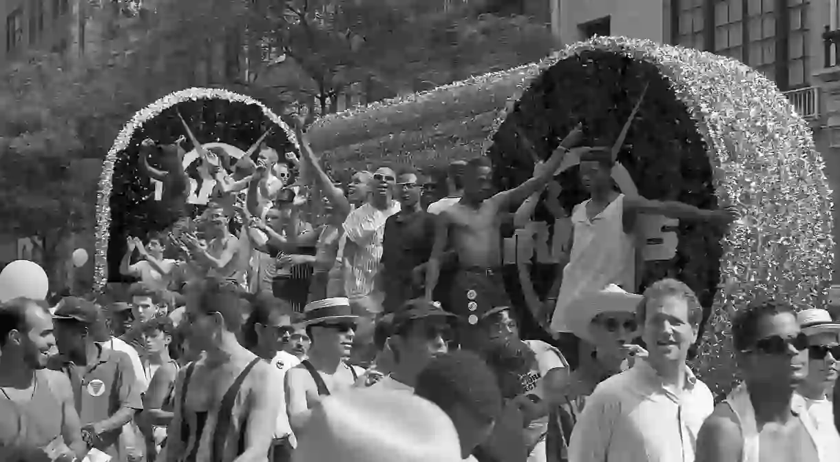 Gay rights activists smile and wave to the crowd from a parade float during the 1989 Gay Pride Parade in Greenwich Village, Manhattan commemorating the 20th anniversary of the Stonewall Riots