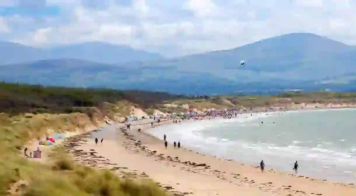 Visitors to Newborough Beach are even treated to spectacular views of Snowdonia National Park