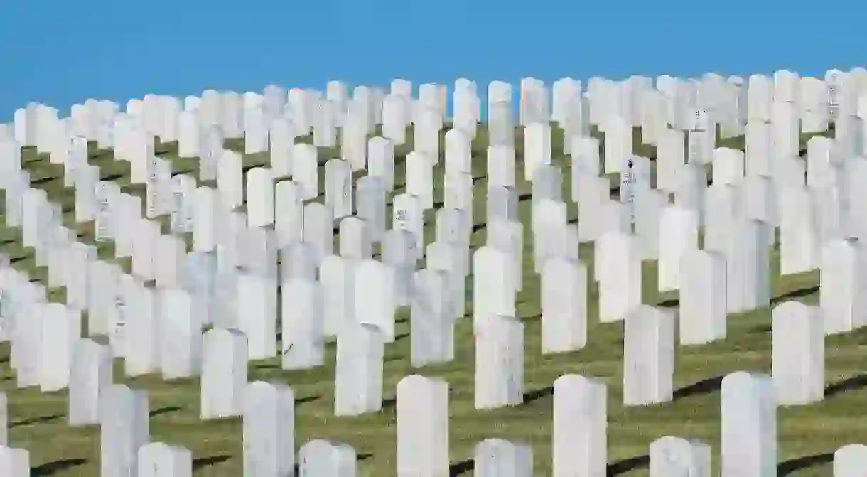 Gravestones line the green hills of the historic Santa Fe National Cemetery in New Mexico