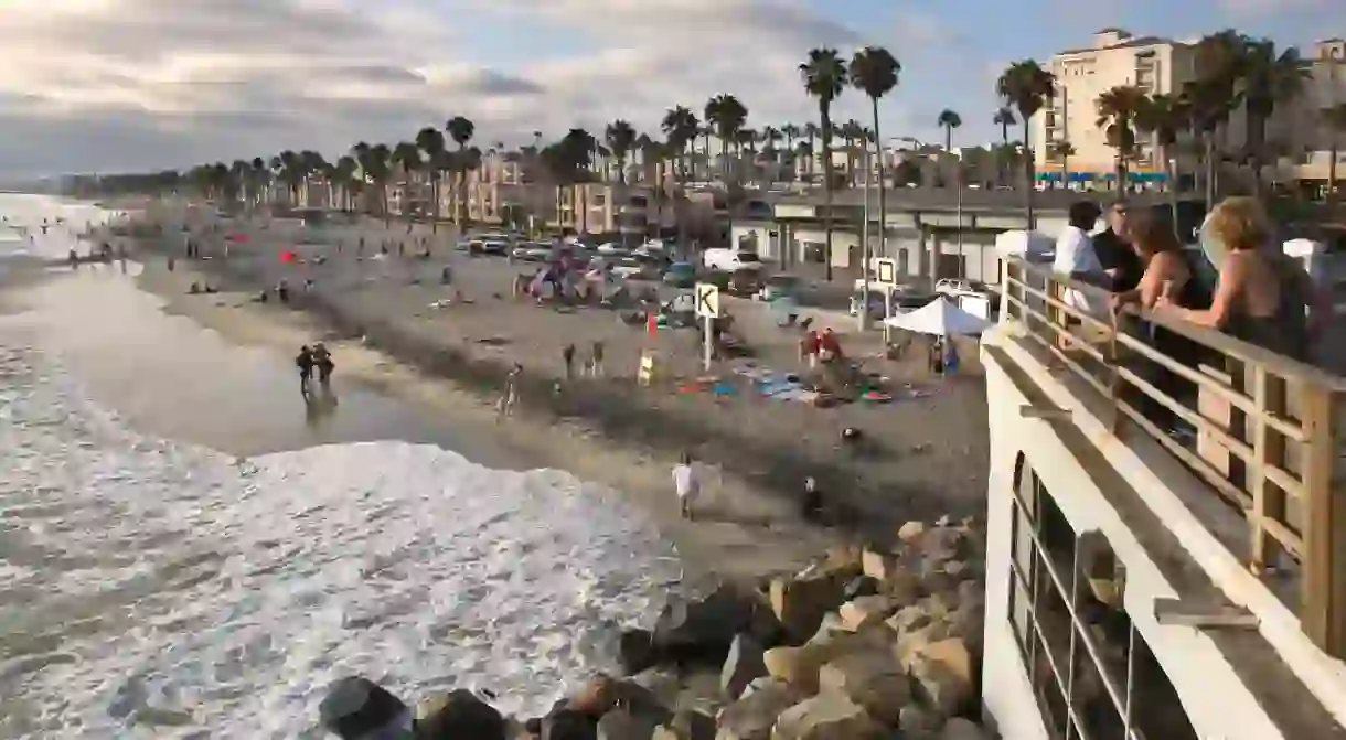 Beach-goers enjoying the outdoors at the Oceanside Pier