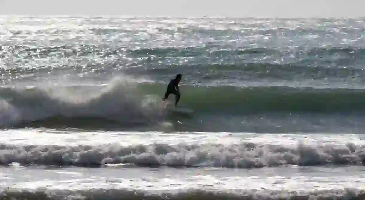 Man surfing a wave in Mediterranean sea