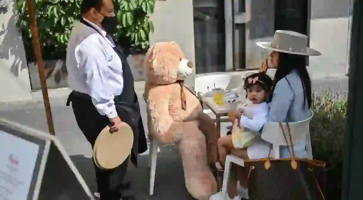 A teddy bear sits at a customers table in a restaurant in the Polanco neighborhood of Mexico City to encourage social distancing