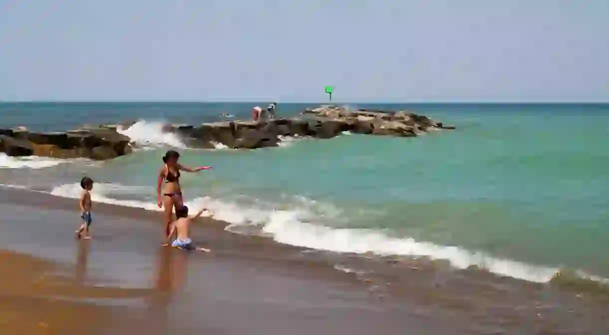 Beachgoers play at Lake Michigan beach, New Buffalo, Michigan.