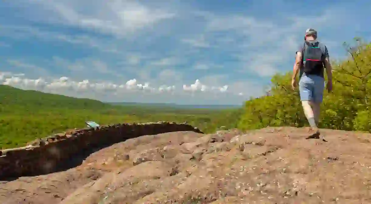 A hiker on the escarpment above Lake of the Clouds in Porcupine Mountains Wilderness State Park