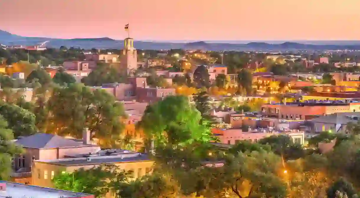 Downtown Santa Fe lights up in a cozy haze as dusk falls