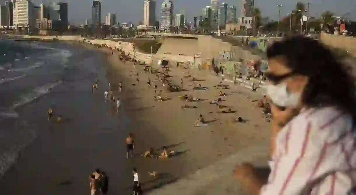 In Tel Aviv, masks are mandatory everywhere in public, even on the beach, and the number of people allowed inside restaurants and bars is restricted