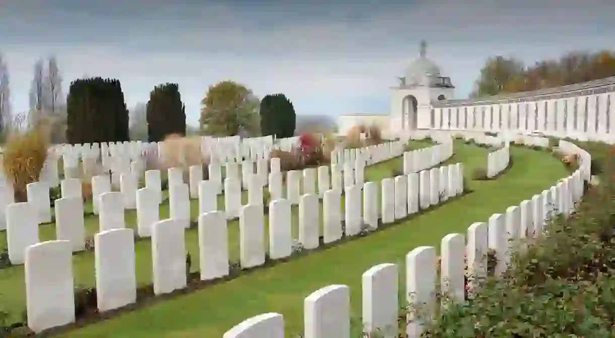 See the graves of World War I soldiers at Tyne Cot Cemetery just outside Ypres