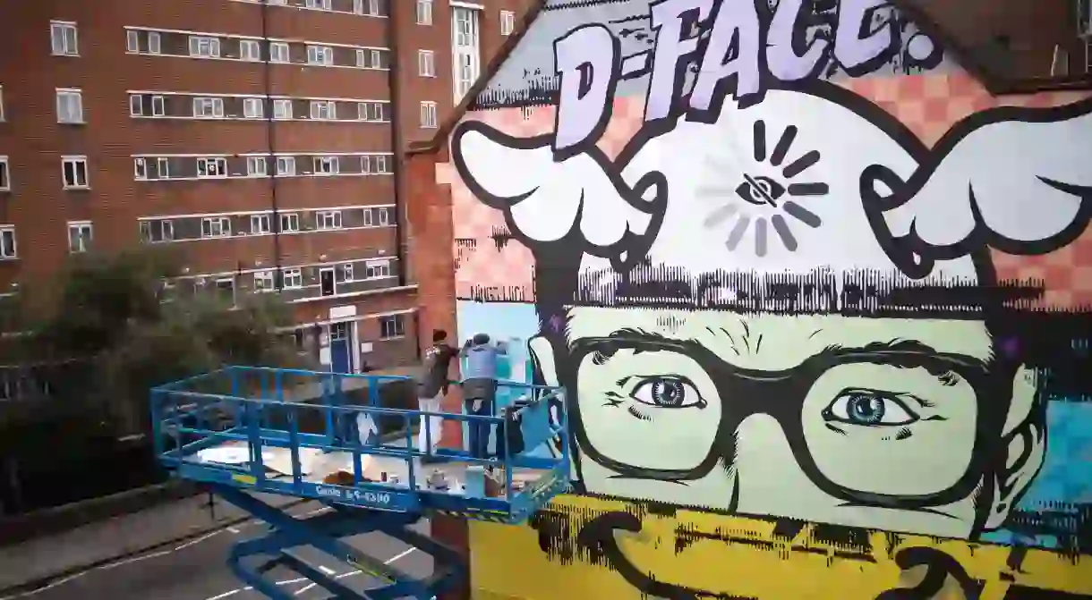 D*Face working on his mural in Kings Cross