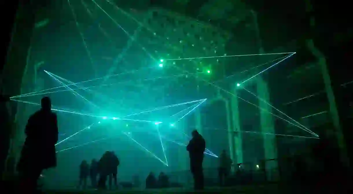 Visitors experience a laser and sound installation at the CTM Festival at Kraftwerk Berlin