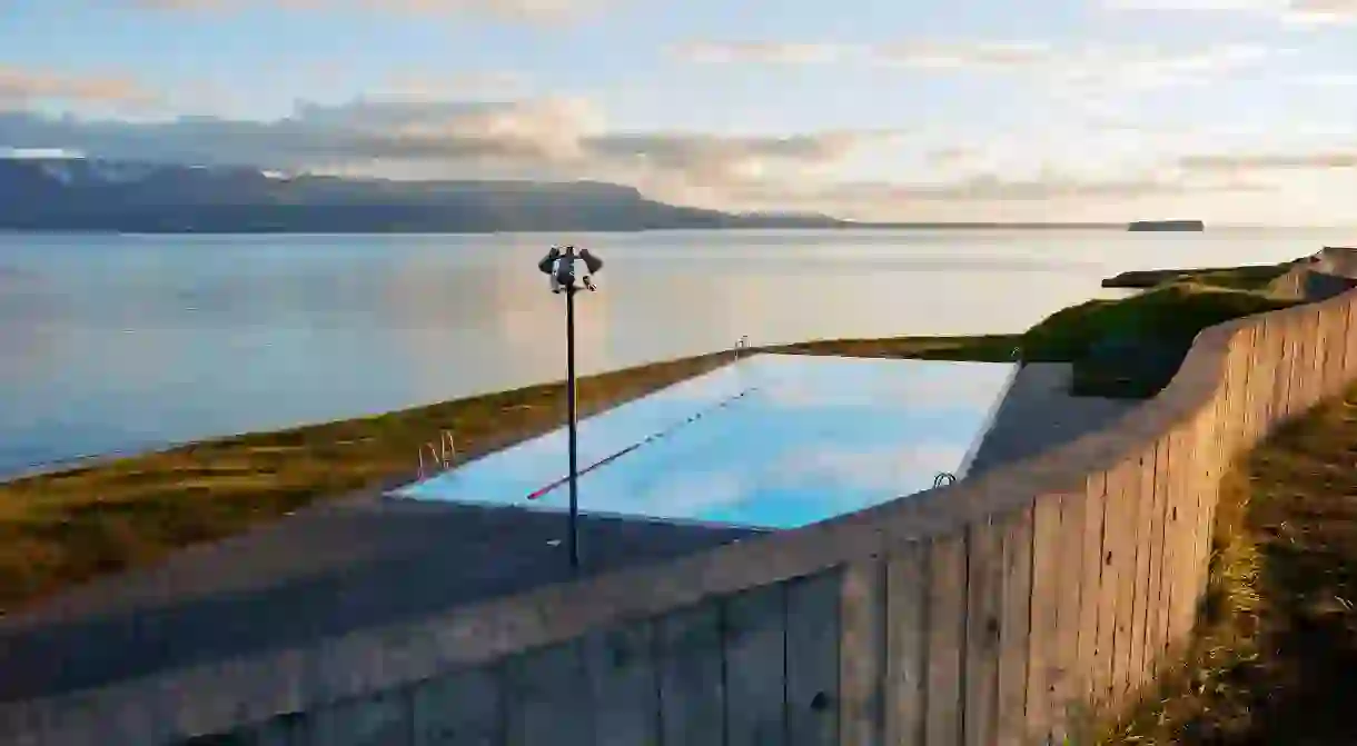 Enjoy the view from Hofsós Swimming Pool towards the ocean and the island of Drangey, Iceland