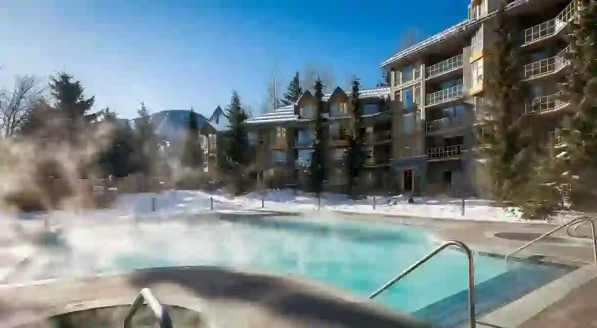 Relax in the heated pool while admiring the gorgeous scenery at the Whistler Cascade Lodge by Vacasa