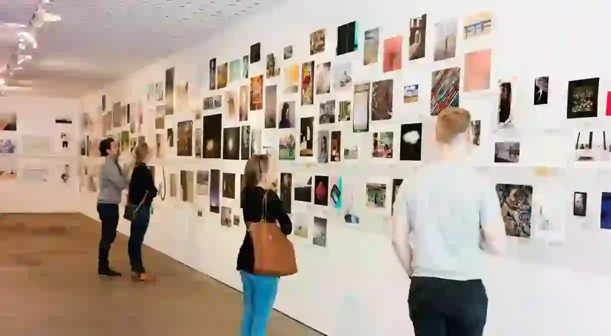 People enjoy an exhibition at the Centre for Contemporary Photography, Melbourne