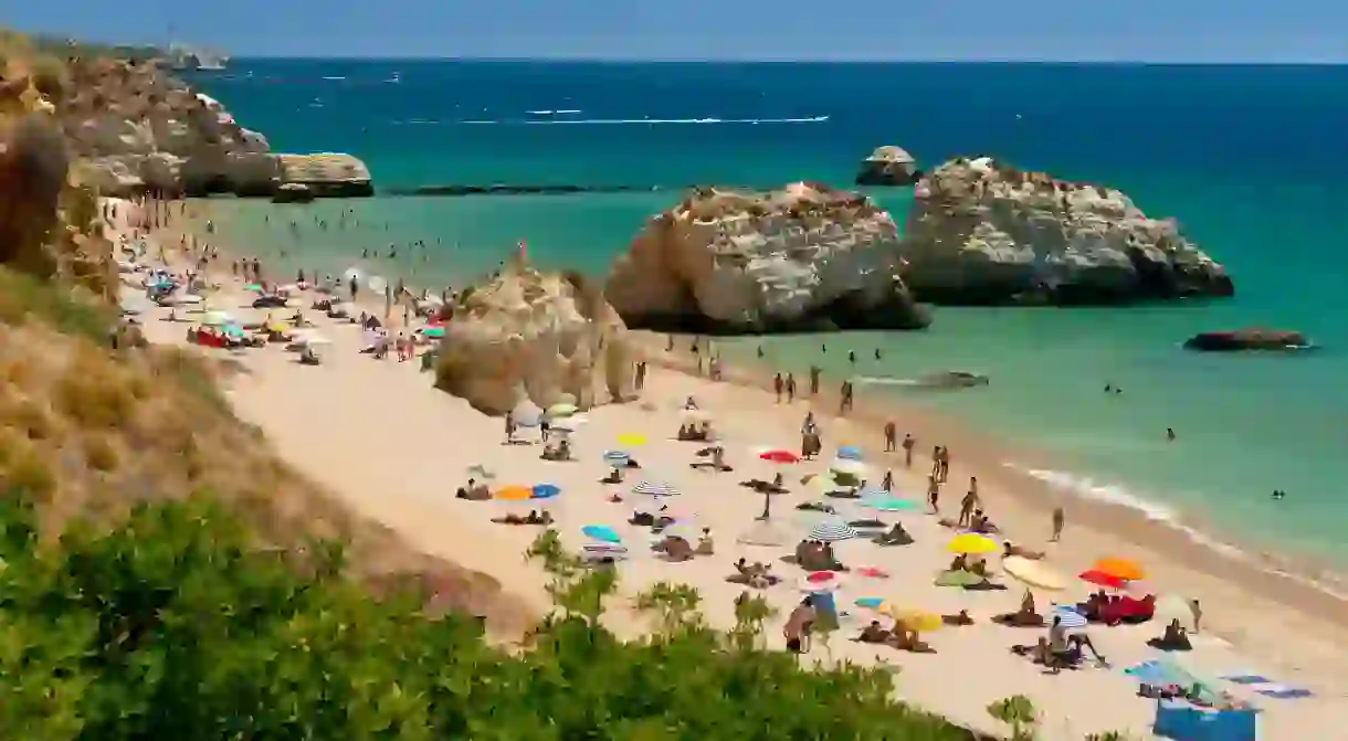 Praia da Rocha beach is popular with locals and visitors from around the world