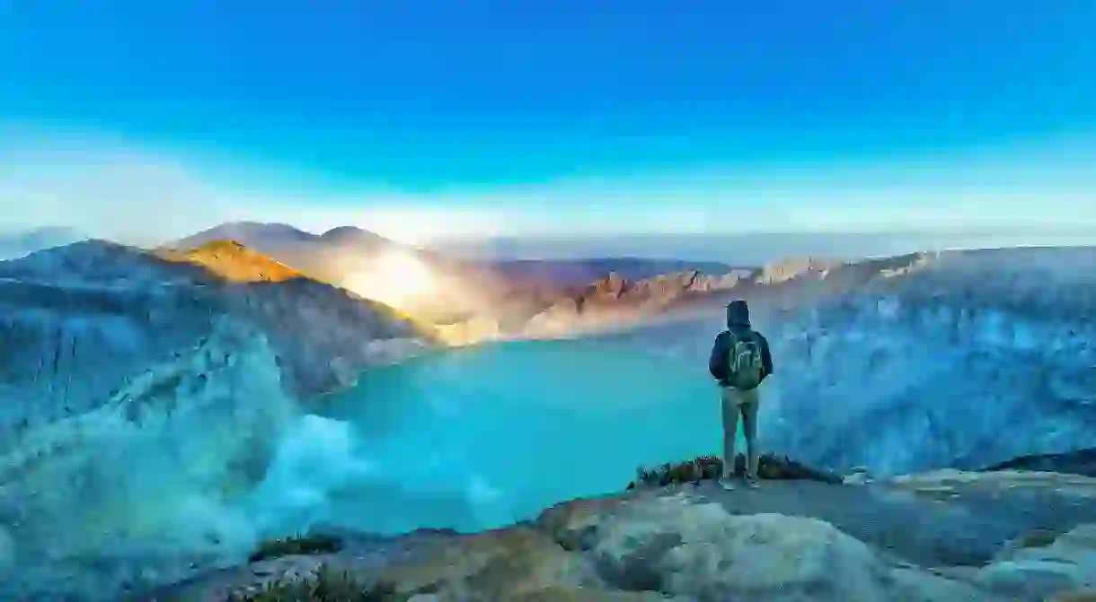 A hiker takes in the view at Kawah Ijen, Banyuwangi