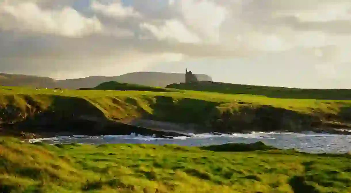 Watch the waves break against the green cliffs of Donegal, Ireland