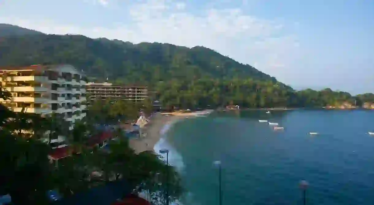 Verdant mountains provide a scenic backdrop to Mismaloya Beach in Puerto Vallarta, Mexico