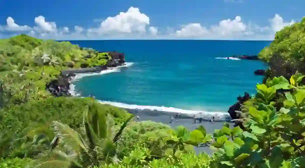 Lush vegetation surrounds a cove on Maui, Hawaii