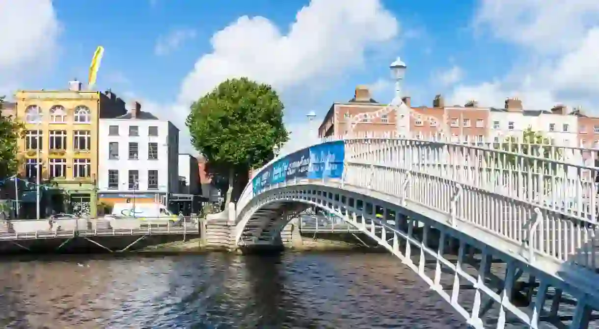 Cross the iconic Hapenny Bridge over the River Liffey on a trip to Dublin