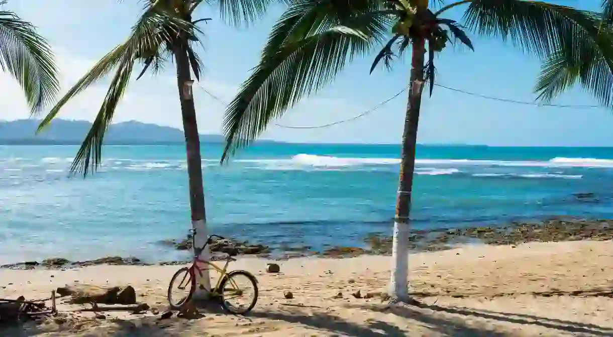 Park your bike against a palm tree and enjoy the beaches of Puerto Viejo de Talamanca, Costa Rica