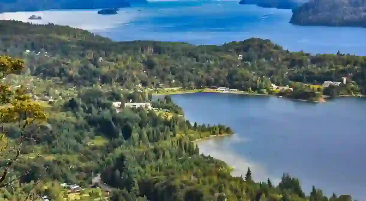 Lush forests and the stunning blue waters of Nahuel Huapi Lake await in San Carlos de Bariloche, Argentina