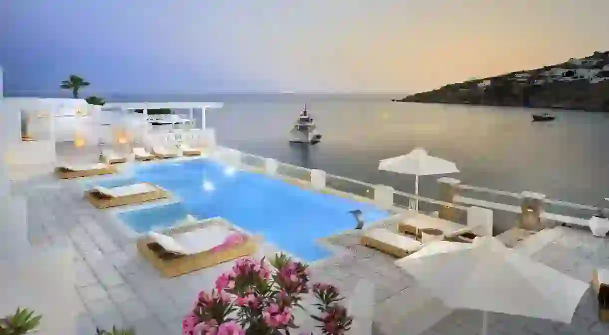 Take in the view as you unwind poolside at the Palladium Hotel on Mykonos, Greece