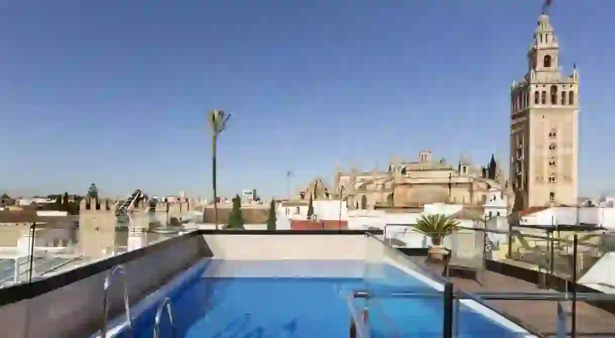 The rooftop pool at Hotel Casa 1800 overlooks the cathedral and city rooftops in Seville