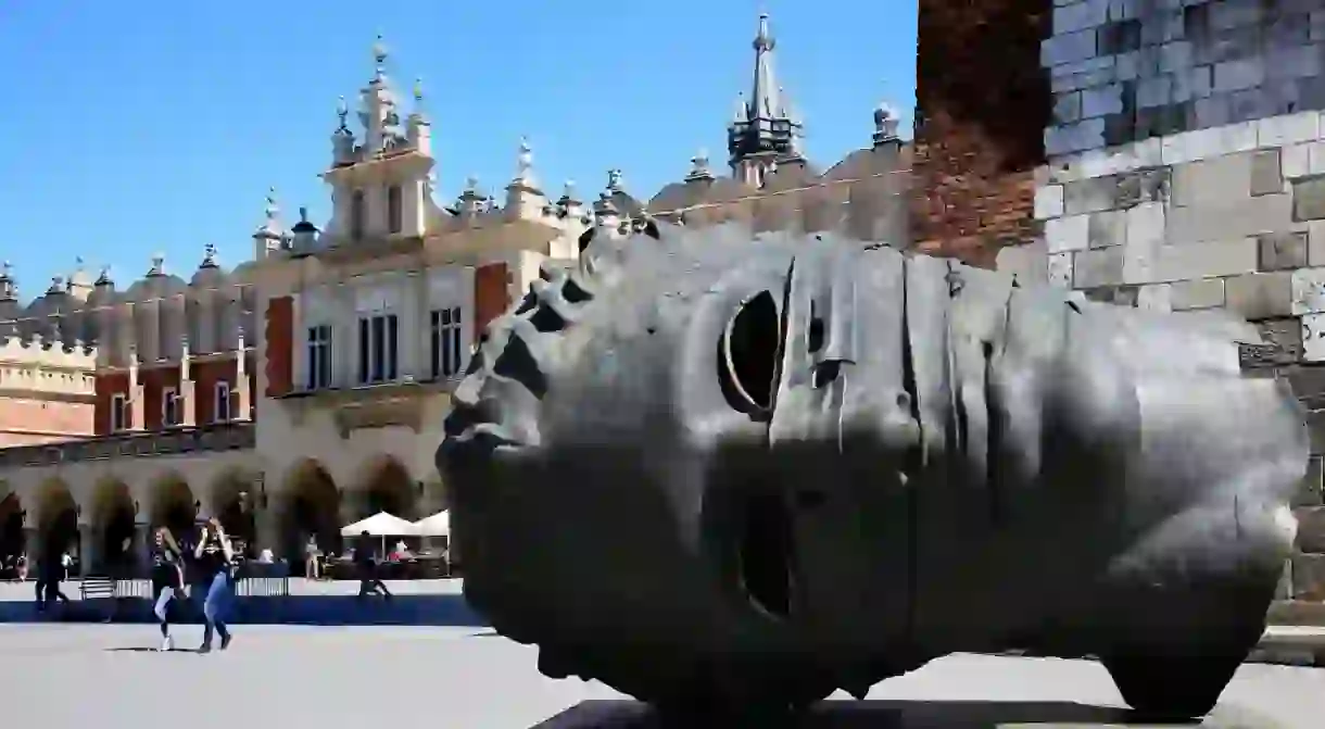 Igor Mitorajs huge hollow statue of Eross head rests in Krakows Market Square