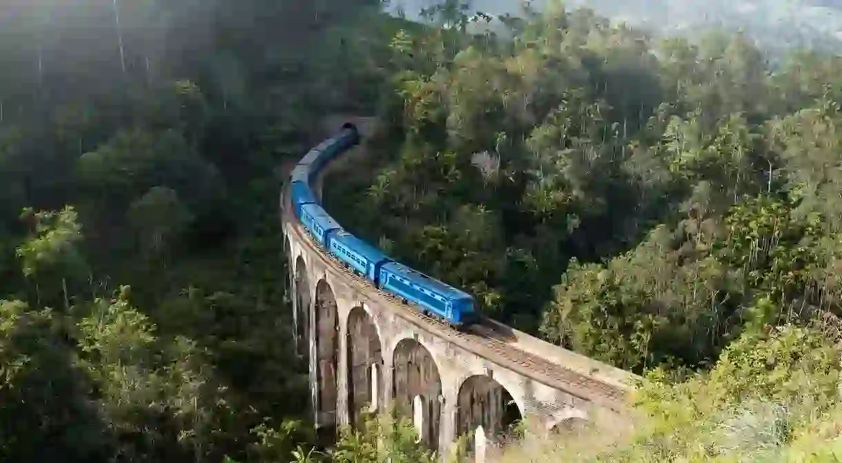 Travelling by train through the mountains in Ella, Sri Lanka, gives you the chance to take in forests, rivers and tea plantations