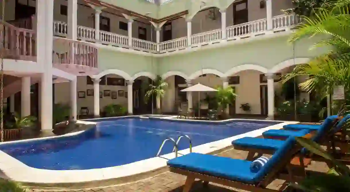 Stay in a magnificent colonial mansion whose blue-tiled pool was the first in the city