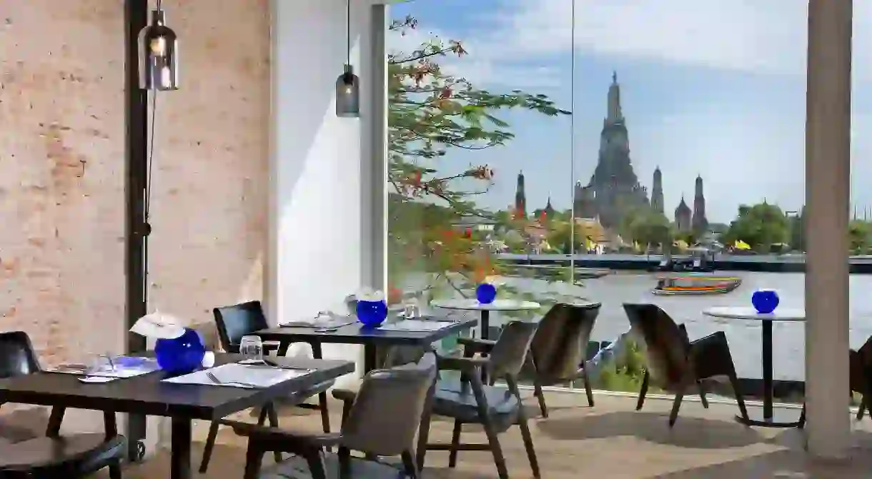 Directly overlook the Temple of Dawn from your riverside hotel