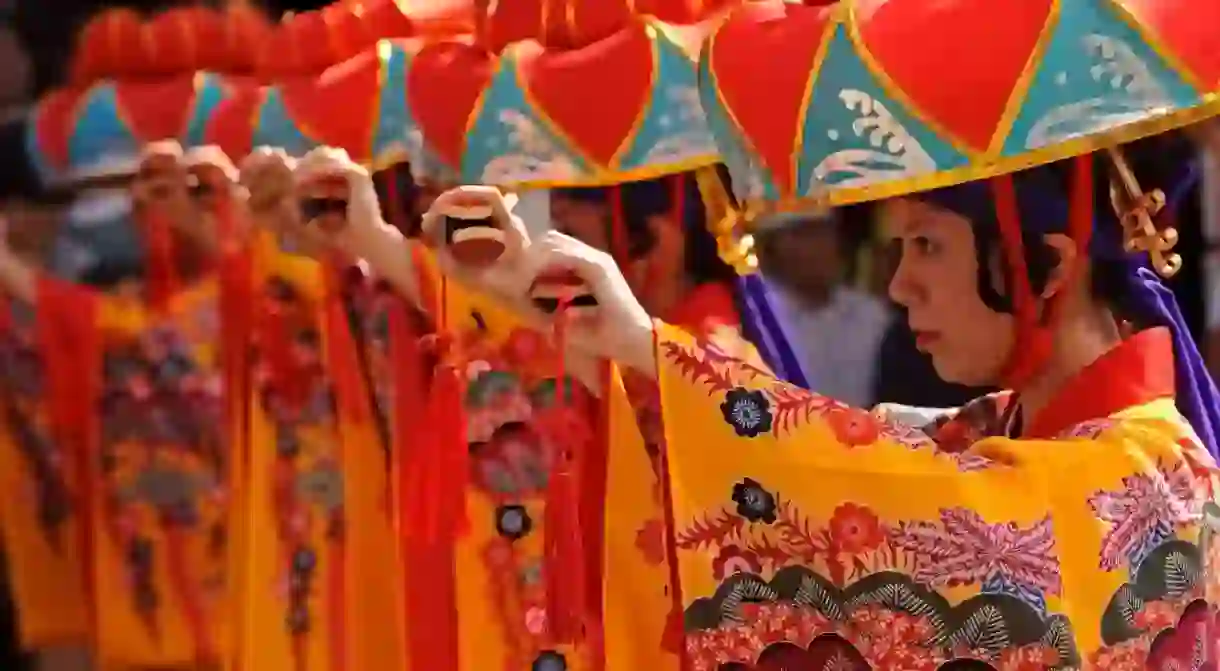 Performers wearing bingata kimonos dance at a local festival celebrating Ryukyu culture, in Okinawa