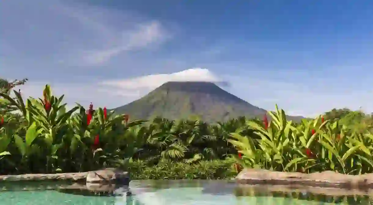 Enjoy a view of the Arenal Volcano while soaking in a thermal pool at the Springs Resort