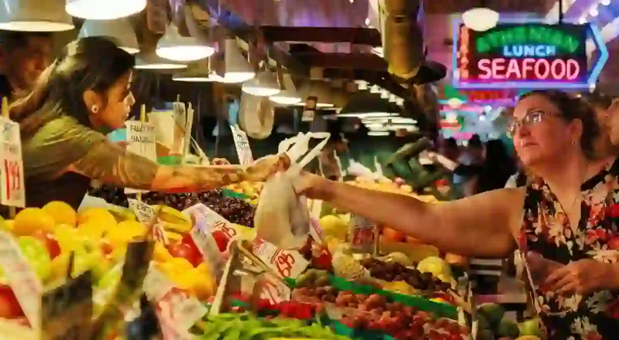 Shoppers pick up fresh produce at Pike Place Market in downtown Seattle