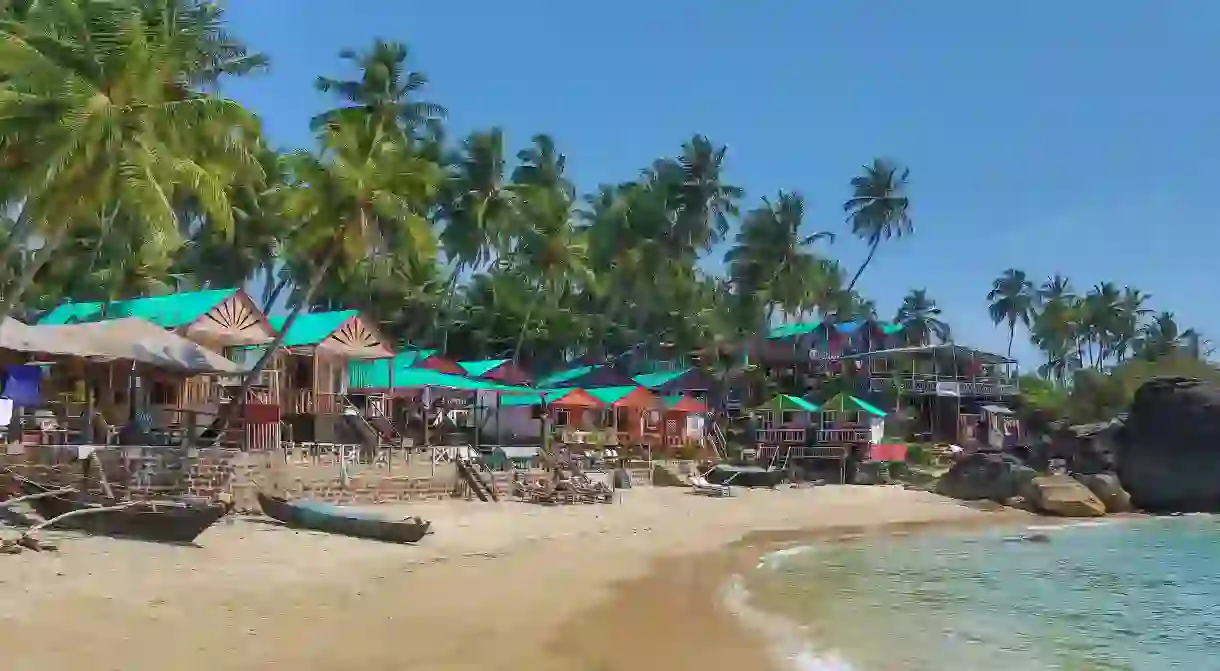 Part of the mile-long white crescent of sand that makes up Palolem Beach, studded with fishing boats, beach huts and ringed by swaying palms.