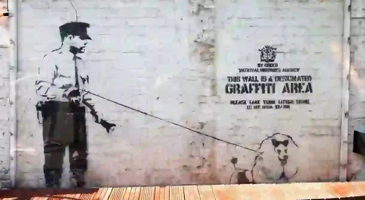 A Banksy stencil graffiti sits on the wall of the Cargo Club on Rivington Street, Shoreditch