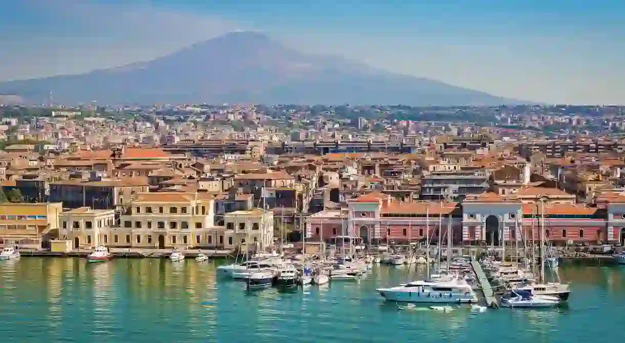 On the horizon, Mount Etna provides a beautiful backdrop to the cityscape of Catania, Italy