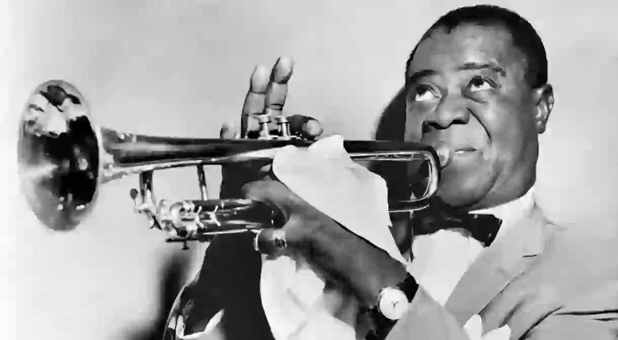 One of the founding fathers of Jazz, Louis Armstrong plays the trumpet in the 1950s