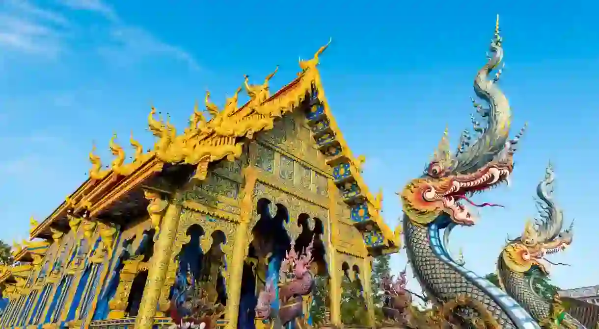 The striking blue Wat Rong Suea Ten temple is one of the gems you will find during a stay in Chiang Rai