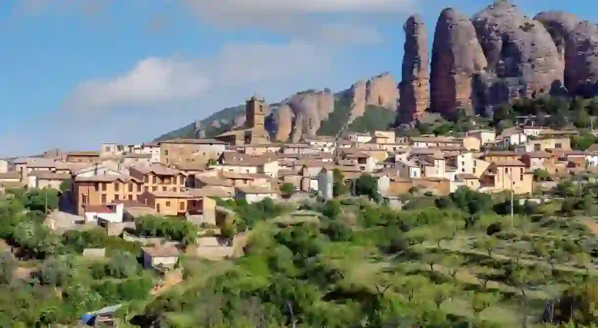 Village of Aguero beneath the conglomerate rock formations of the Mallos de Riglos