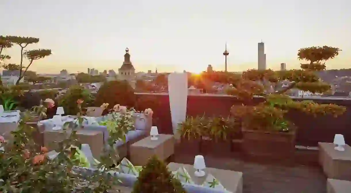 Enjoy a drink at sunset on the rooftop terrace at the Savoy