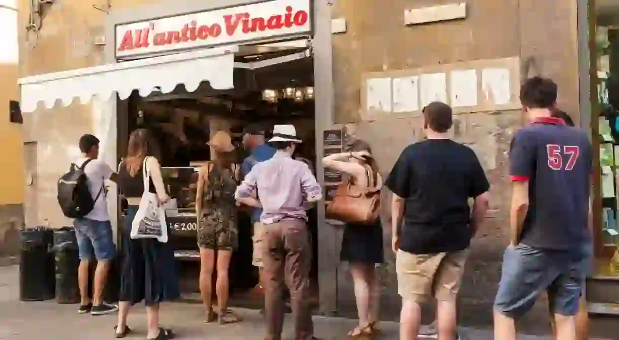 Locals in Florence queue at AllAntico Vinaio, one of the places you should visit on a foodie trek through Italy