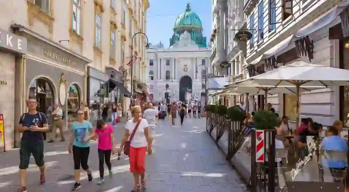 Life in Vienna is drenched in culture and the arts; here, a restaurant-lined street leads to the Hofburg palace