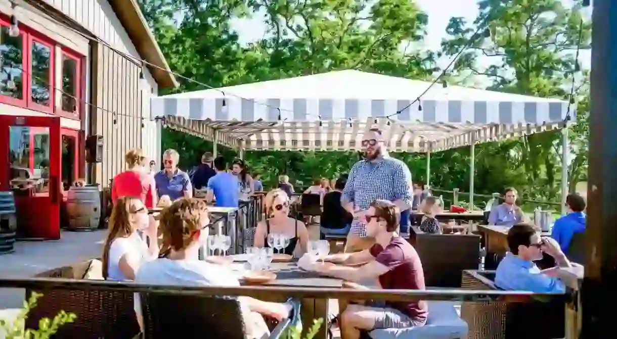 Guests enjoy drinks on the front deck at Lieb Cellars-Bridge Lane, Long Island