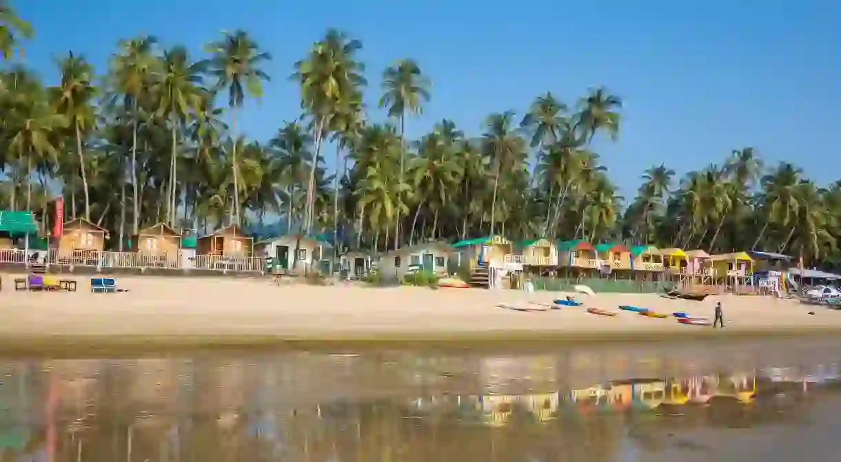 Calm waters lap the shore of palm-fringed, laid-back Palolem Beach in Goa, India.