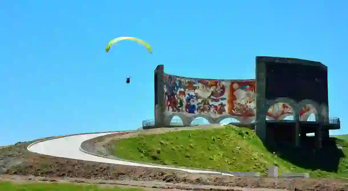 Go paragliding to get a bird’s-eye view of Georgia, including the Russia-Georgia Friendship Monument