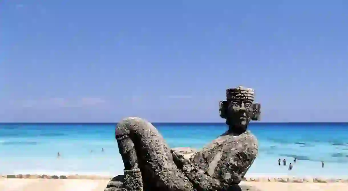 Chac Mool, the Mayan rain god, is immortalized in stone on the beach in Cancún