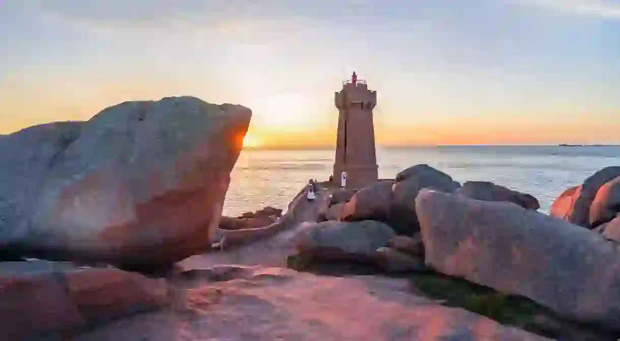 The pink granite lighthouse of Ile Louët sits by the Château du Taureau offshore fortress in pretty Morlaix Bay