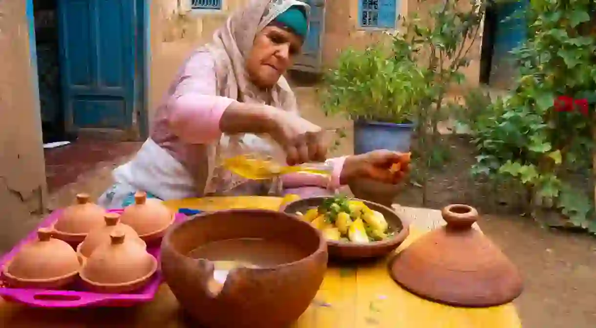 A Berber woman prepares a tagine lunch