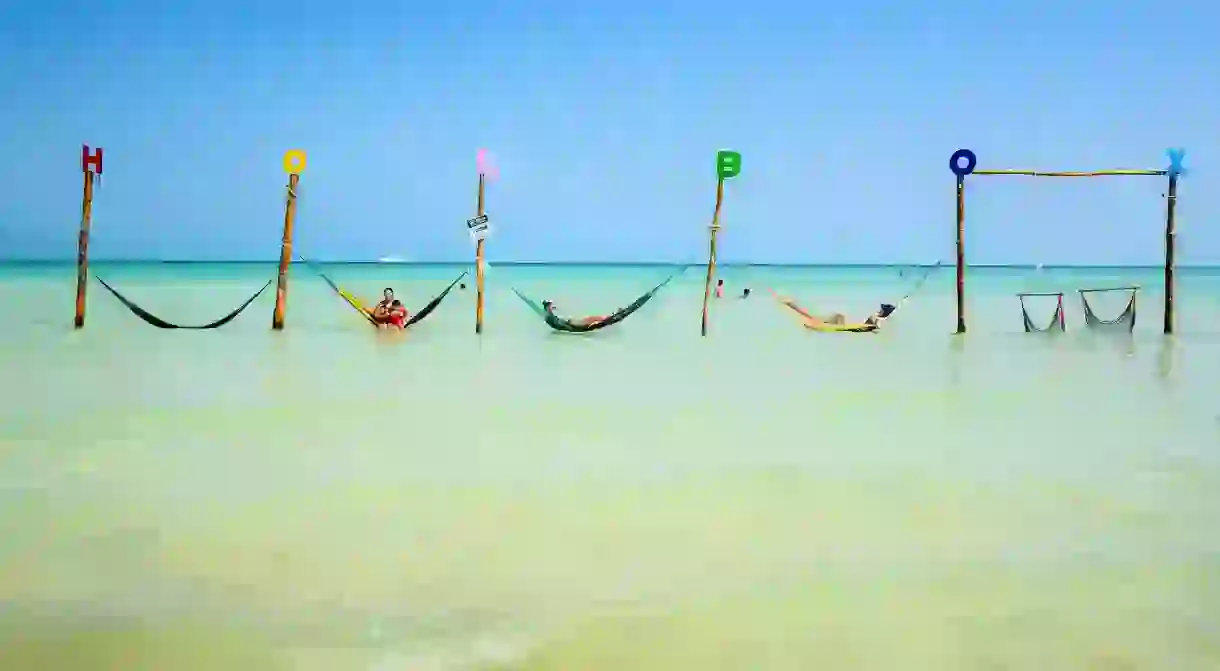 Chill in a hammock over the water on Isla Holbox, Mexico